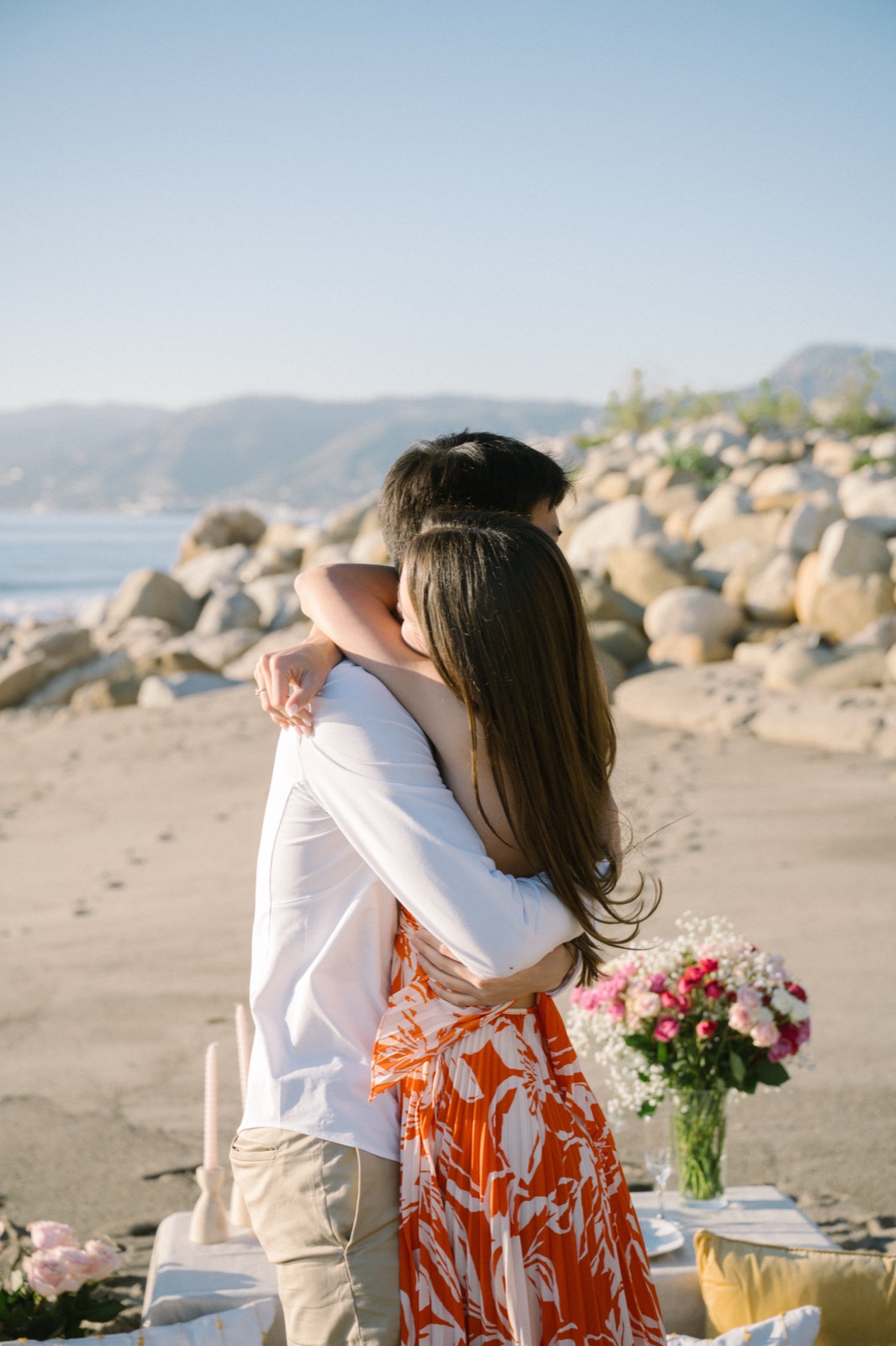 Jonathan and Courtney embrace on the beach after the proposal